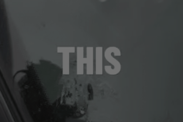 Dark image with bold text “THIS” over etched bird droppings on car paint, showing visible surface damage