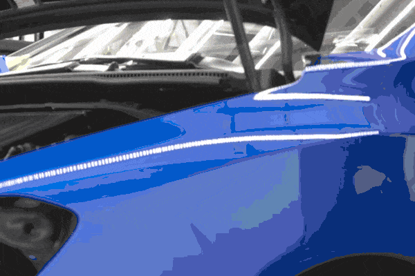 Close-up of a heat gun being used to apply a vehicle wrap during paint protection film installation