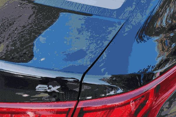 Polishing a car's black paint surface during the preparation stage for paint protection application