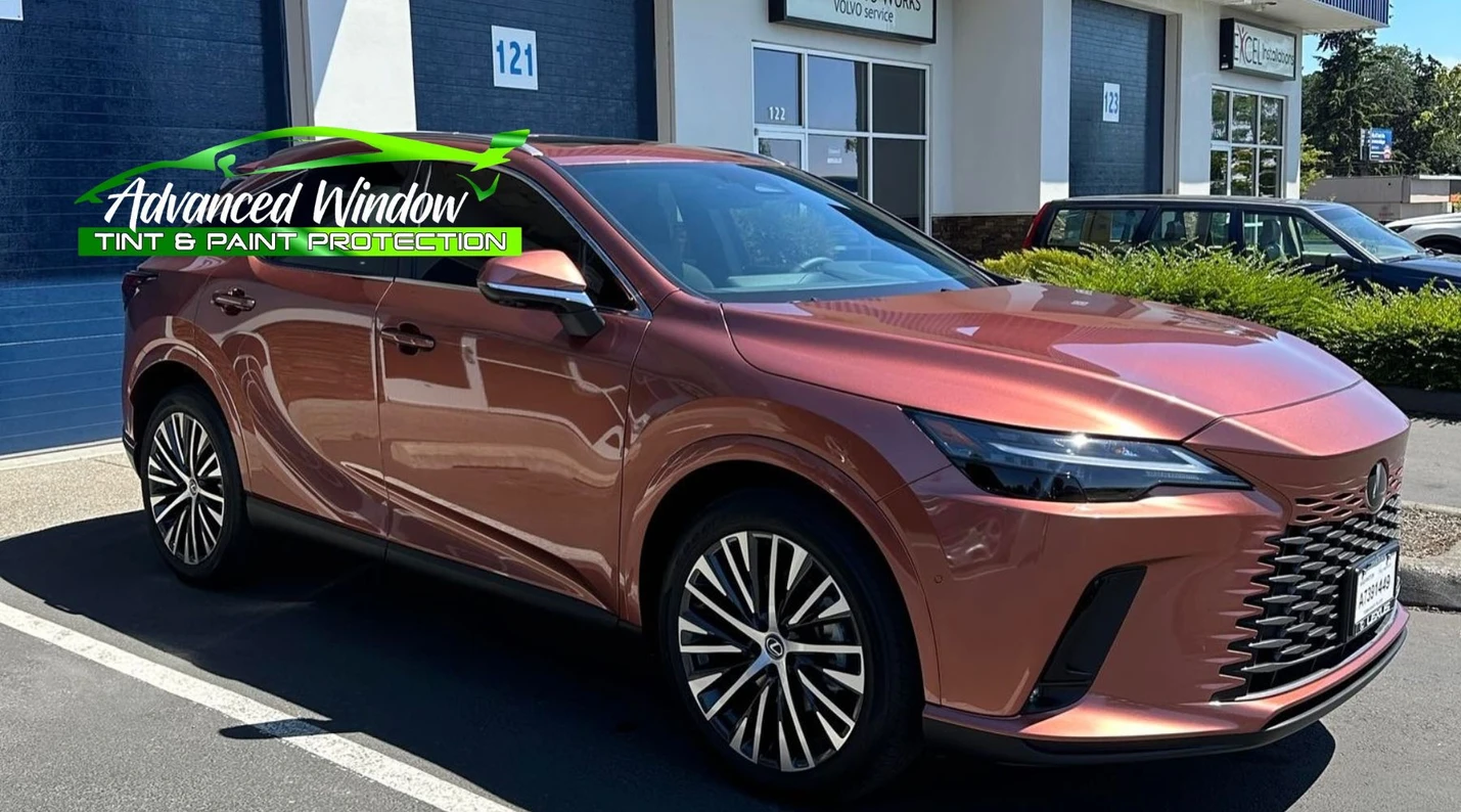 Shiny bronze Lexus SUV parked outside shop with UV-protective window tint applied by Advanced Window Tint & Paint Protection