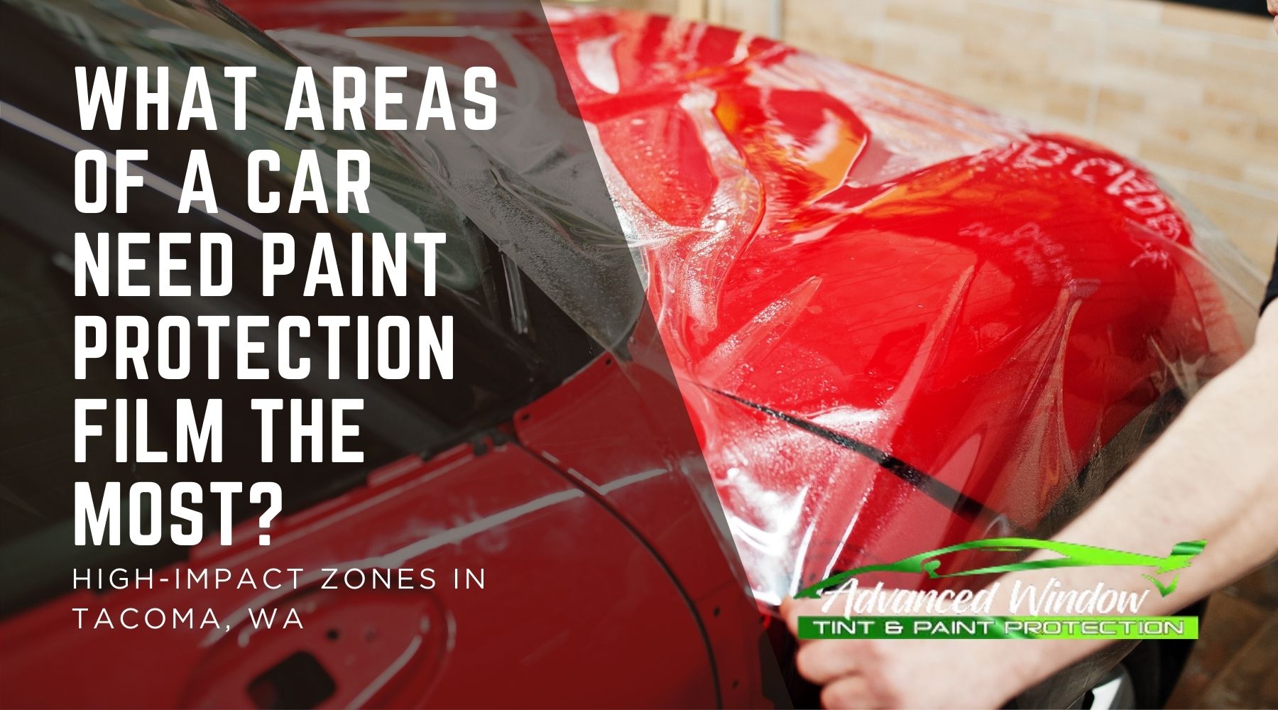 Technician applying paint protection film to the front of a red car in a professional auto shop in Tacoma, WA.