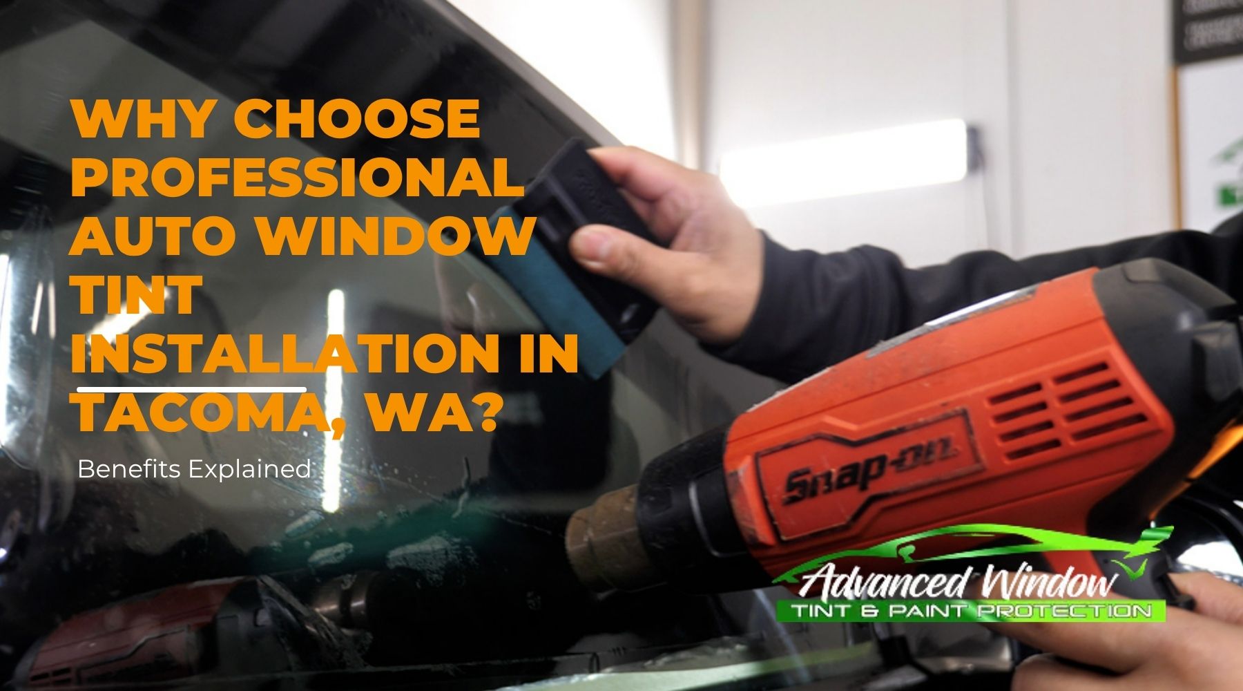 Technician applying professional auto window tint installation on a car in Tacoma, WA using a heat gun and tint tool