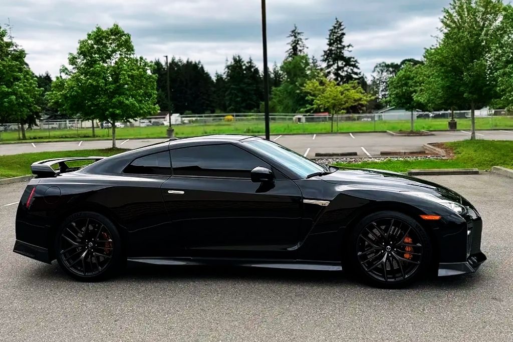 Black sports car with tinted windows parked outdoors in Tacoma, WA.