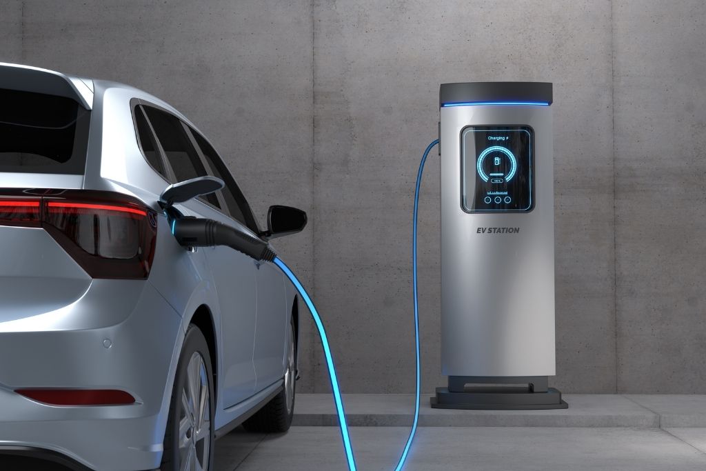 Electric vehicle connected to an EV charging station, representing Tesla and EV ownership and protection considerations in Tacoma, WA.