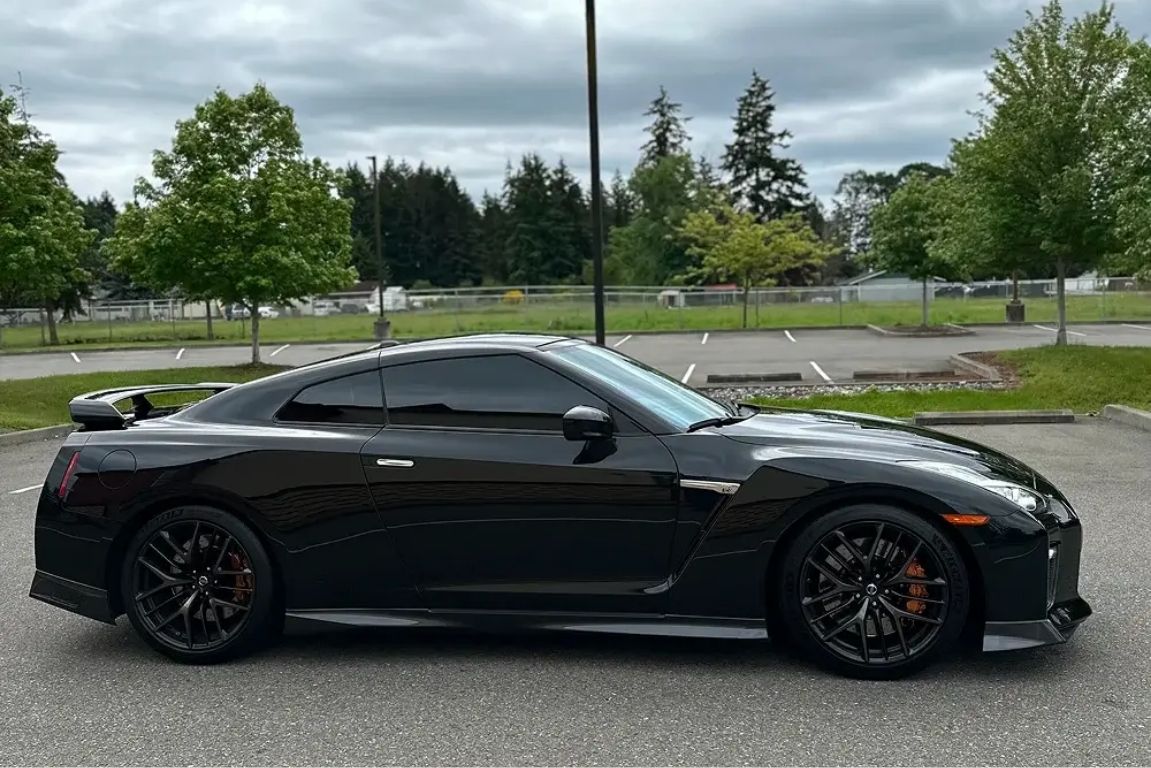 Black sports coupe with tinted windows and glossy paint parked outdoors in Tacoma, Washington.