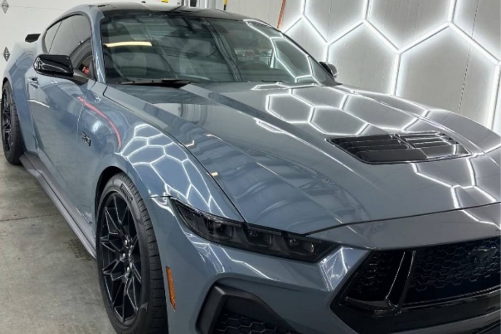 Gray performance car with a glossy paint finish inside the Advanced Window Tinting & PPF shop in Tacoma-area Washington.